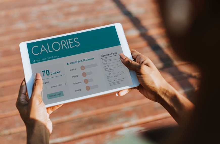 a person holding a small screen with calorie information
